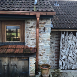 photograph showing copper gutter length half round, copper downpipe round, copper downpipe shoe round installed